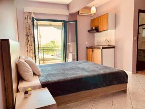 a bedroom with a large bed and a kitchen at Acherontas in Gliki