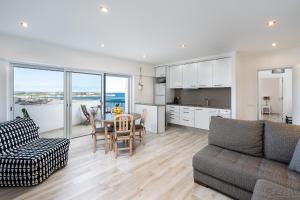a living room with a couch and a table at Heritage Caeli in Portimão