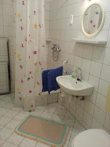 a bathroom with a sink and a toilet and a shower at Relax Apartmanok in Zalakaros
