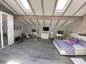a bedroom with a bed and a brick wall at CASA MARTINELLI in Limone sul Garda