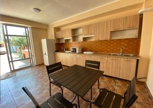 a kitchen with a table and chairs in a room at Катюша морская in Zatoka