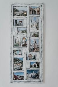 a painting of a white picture frame on a wall at Casa Calle Real 87 in Frigiliana