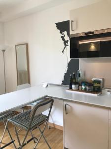 a kitchen with a white counter and a chair at Casa Chiara in Riva del Garda