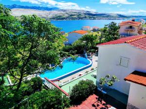 an aerial view of a resort with a swimming pool at Family Apartments K&M in Pag