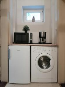 a washing machine in a room with a window at Prestige location apartments Pijarska street in Krakow