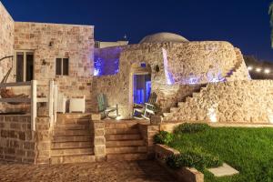 a stone house with stairs in front of it at Relais Il Trullo della Rupe in Ostuni +136 photos