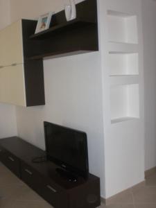 a tv sitting on a stand in a room at Casa Malù in Pula