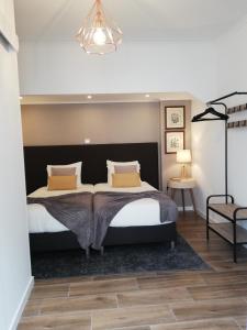 a bedroom with a large bed and a chandelier at Victória Guest House in Furnas