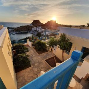 a view from the balcony of a house with the sunset at Finiki Villas in Foinikion