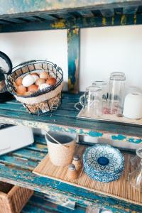 a basket of eggs sitting on a shelf at Le jardin du Castillon in Paradou +7 photos