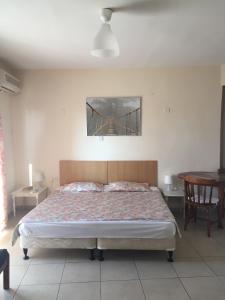 a bedroom with a bed and a bridge painting on the wall at Olimpus Garden Homes in Ayia Napa