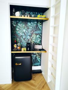 a black refrigerator in a room with a wall at Luxurious Central Studio in Monumental Warehouse in Rotterdam