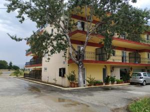 a building with a car parked in front of it at Thomas Vrasna Close To The Sea in Nea Vrasna