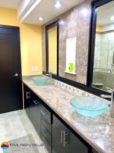 a bathroom with two blue sinks and a shower at Linda Vista 513 in Puerto Peñasco