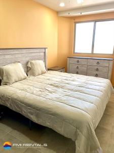 ein großes Bett in einem Schlafzimmer mit Fenster in der Unterkunft Linda Vista 513 in Puerto Peñasco