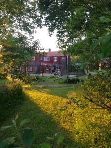a park with a playground and a swing at Sjugare Gård Bed & Breakfast in Leksand
