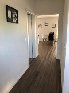 an empty living room with a hard wood floor at Ferienwohnung Rheinfelden-Herten in Herten