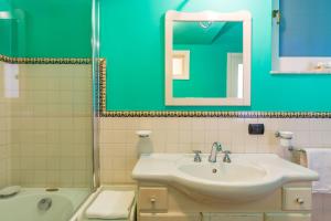 a bathroom with a sink and a mirror at Casa 45 in Salerno