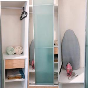 a glass cabinet with a surfboard in it at Agrima Studio Apartment in Kota Bharu
