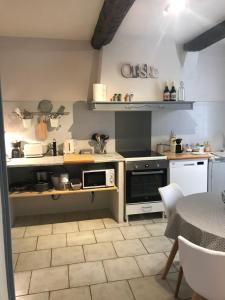 a kitchen with a sink and a stove at Au cœur de Céreste in Céreste