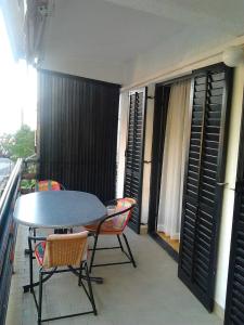 a table and chairs on a balcony with a table at Apartments Krpan in Donja Klada