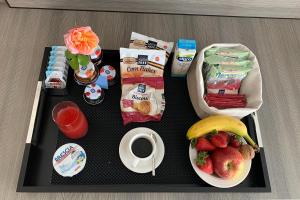 a tray with breakfast foods and a cup of coffee at Viola Relais in Desenzano del Garda