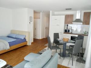 a bedroom with a bed and a table and chairs at Apartments Alice & Julia in Baden-Baden