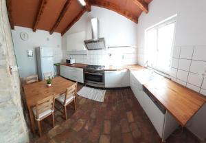 a large kitchen with a wooden table and a wooden tableablish at Apartma Fiorina in Sečovlje