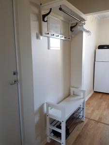 een keuken met een witte koelkast en een witte bank bij Aia Apartment in Haapsalu