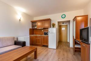 a living room with a couch and a white refrigerator at Avalon appartament da Lary in Sunny Beach