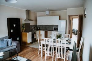 a kitchen and living room with a table and chairs at Flats near football clubs in Liverpool
