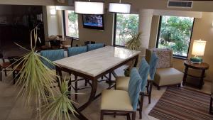 a dining room with a wooden table and chairs at Best Western Intracoastal Inn in Jupiter