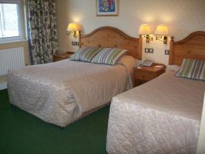 a hotel room with two beds and a telephone at Elstead Hotel in Bournemouth