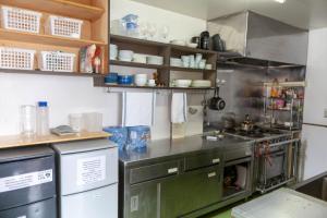 a kitchen with a sink and a stove at Niseko Ski Lodge - Hirafu in Kutchan