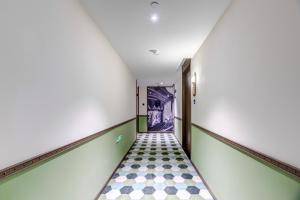 a hallway with a checkered floor in an empty room at Happy Dragon City Culture Hotel-Tianjin Draum Tower & Dayuecheng shopping mall in Tianjin