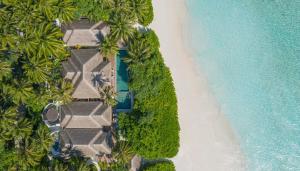 an aerial view of the beach and the ocean at Anantara Kihavah Maldives Villas in Baa Atoll