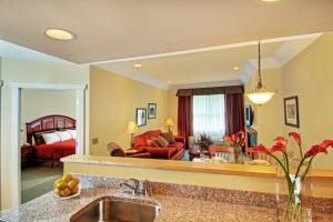 a kitchen with a sink and a living room at The Pointe at Castle Hill Resort & Spa in Ludlow