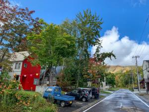 a residential street with cars parked in a parking lot at Niseko Ski Lodge - Hirafu in Kutchan