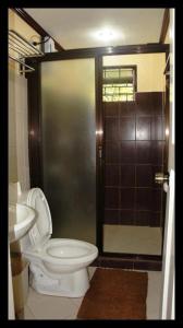 a bathroom with a toilet and a shower at Casa del Rio Resort in Pinagsanghan