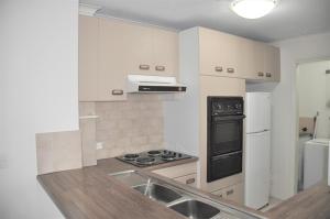 a kitchen with a sink and a stove top oven at Accommodation Sydney City Centre - 2 Bedroom Apartment with Balcony on Top Floor in Sydney