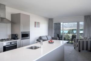 a kitchen and living room with a view of the ocean at Peppers Bluewater Resort in Lake Tekapo