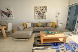 a living room with a couch and a table at Waves Maroochy River in Maroochydore