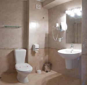 a bathroom with a toilet and a sink at Къща за гости Екстаси in Primorsko +42 photos