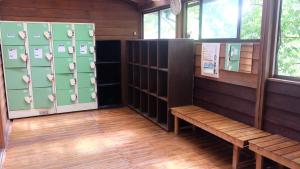 a locker room with lockers and a bench at Kappa Tengoku in Hakone