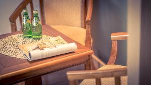 two bottles of beer sitting on a table with a book at Venezia Hotel in Suncheon