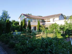 a house with a garden in front of it at Hotel Veagles in Narva-Jõesuu