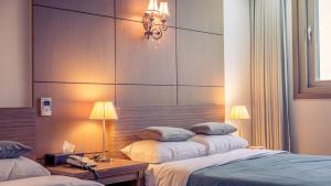 Postel nebo postele na pokoji v ubytování Venezia Hotel