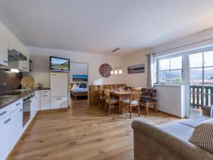 a kitchen and living room with a table and chairs at Apartment Gossner in Westendorf