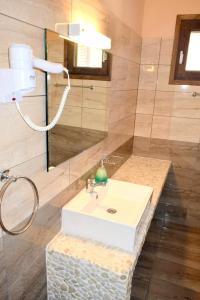 a bathroom with a sink and a shower at Dourios Ippos Apartments in Frikes +67 photos