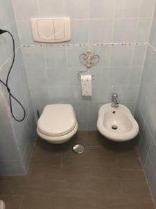 ein Bad mit einem WC und einem Waschbecken in der Unterkunft Al Porto in Gaeta
